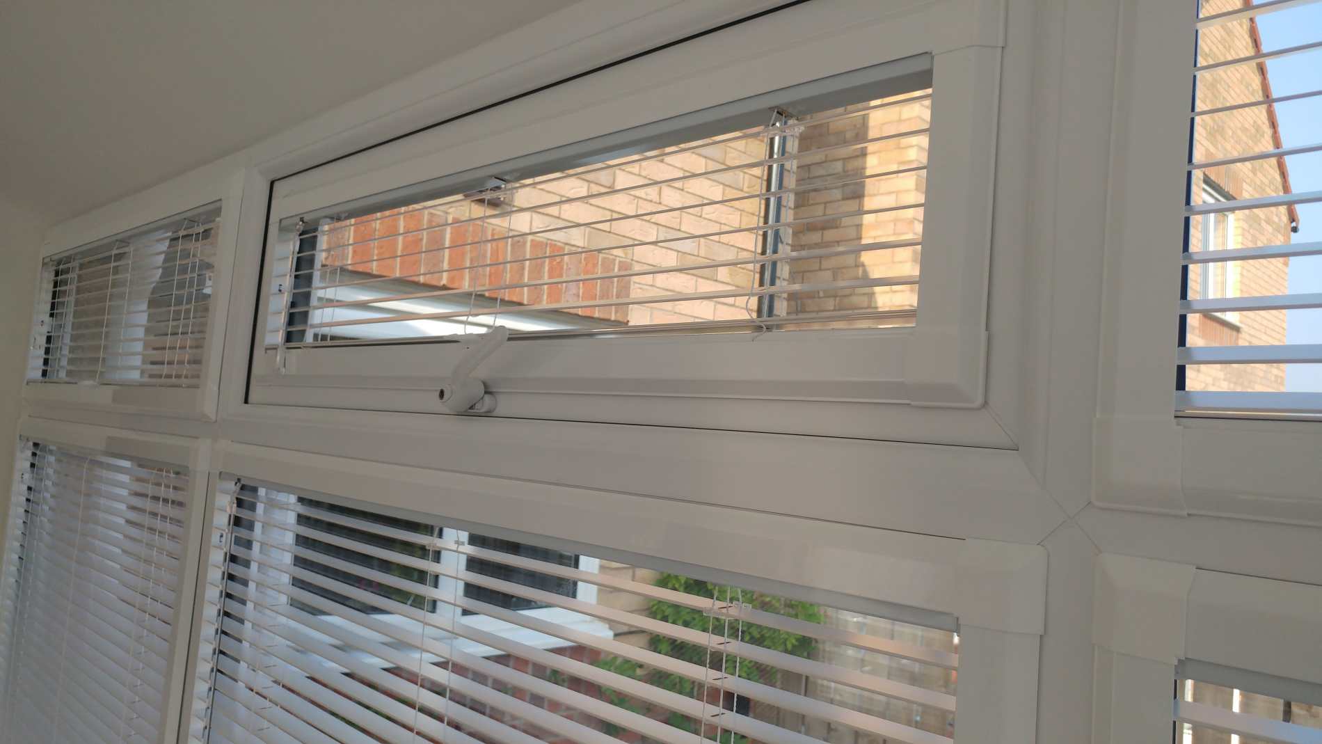 Venetian Perfect Fit blinds fitted around individual bay window panes
