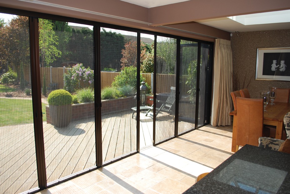 Mesh insect screens across a wide garden doorway, viewed from indoors
