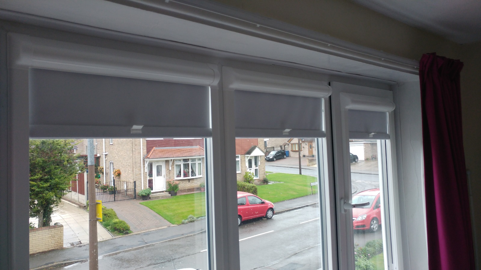 Grey blinds fitted across a bay window